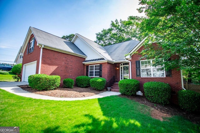 view of front of house with a front lawn, brick siding, and a garage