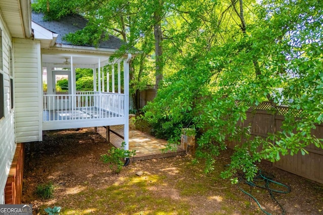 view of yard with a fenced backyard and a sunroom