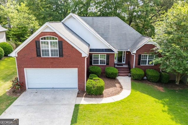 view of front of house featuring brick siding, a garage, concrete driveway, a front yard, and roof with shingles