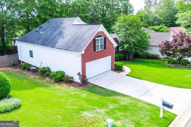 exterior space featuring cooling unit, fence, roof with shingles, a yard, and driveway