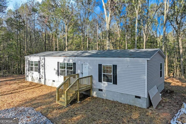 manufactured / mobile home with crawl space and roof with shingles