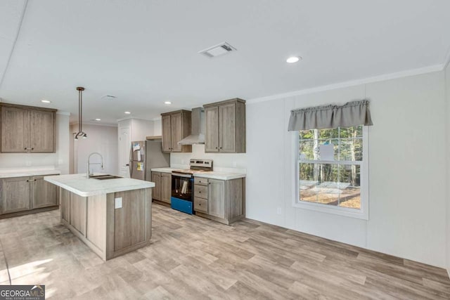kitchen with a sink, freestanding refrigerator, electric range, visible vents, and wall chimney range hood