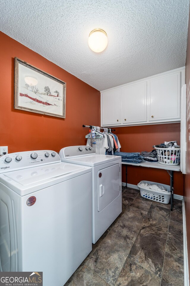 3808 Deer Run Dr, Blackshear, GA 31516 - laundry area with cabinet space, washer and clothes dryer, stone finish flooring, and a textured ceiling
