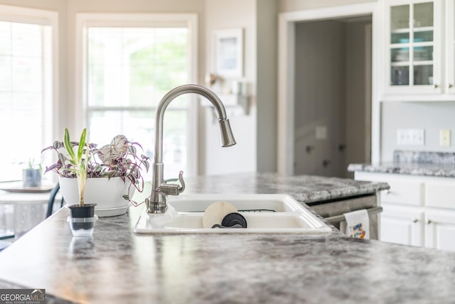 3808 Deer Run Dr, Blackshear, GA 31516 - details with a sink, light stone countertops, glass insert cabinets, and white cabinets