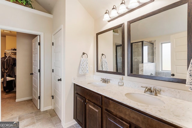 6280 Stillwood Ln, Cumming, GA 30041 - bathroom featuring a stall shower, double vanity, a spacious closet, and lofted ceiling