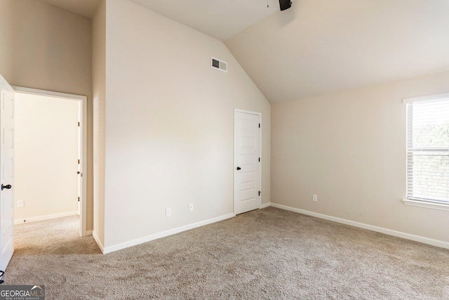 6280 Stillwood Ln, Cumming, GA 30041 - empty room featuring carpet floors, vaulted ceiling, healthy amount of natural light, and a ceiling fan