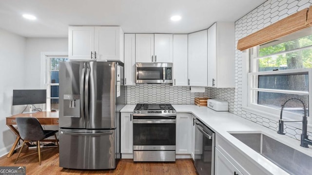 715 Wood Valley Rd, Mableton, GA 30126 - kitchen featuring stainless steel appliances, a sink, backsplash, light countertops, and recessed lighting