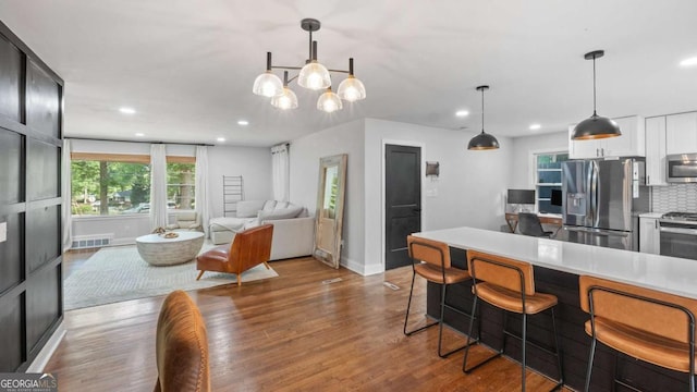 715 Wood Valley Rd, Mableton, GA 30126 - kitchen featuring stainless steel appliances, recessed lighting, wood finished floors, backsplash, and baseboards