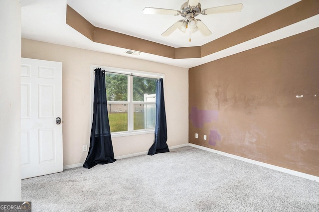 carpeted spare room with baseboards and ceiling fan
