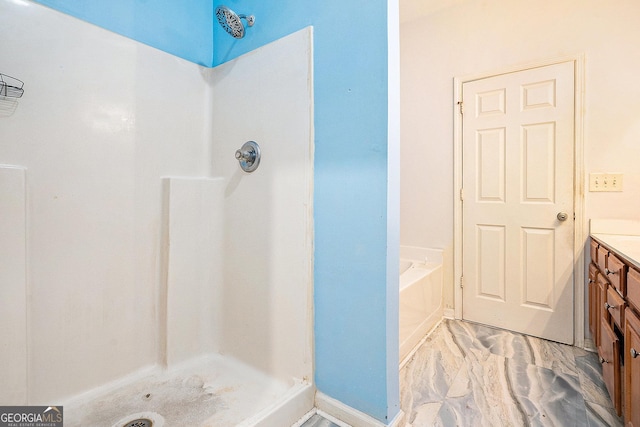 full bath featuring a stall shower, marble finish floors, vanity, and a garden tub