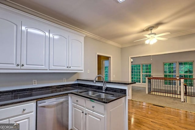 kitchen featuring a sink, a peninsula, dishwasher, ceiling fan, and white cabinetry