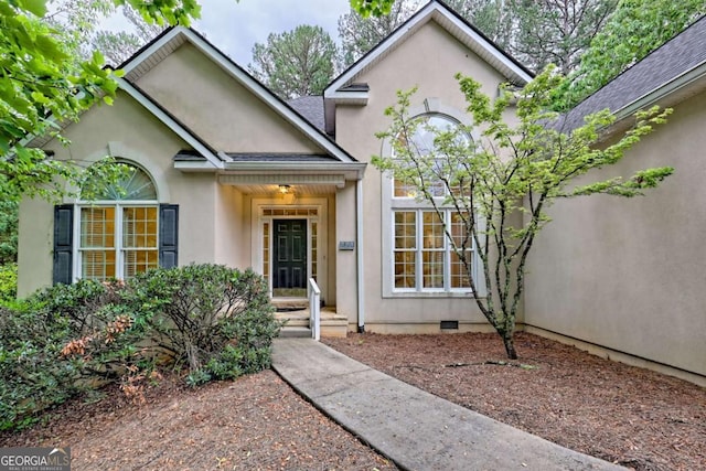 view of front facade featuring stucco siding and crawl space