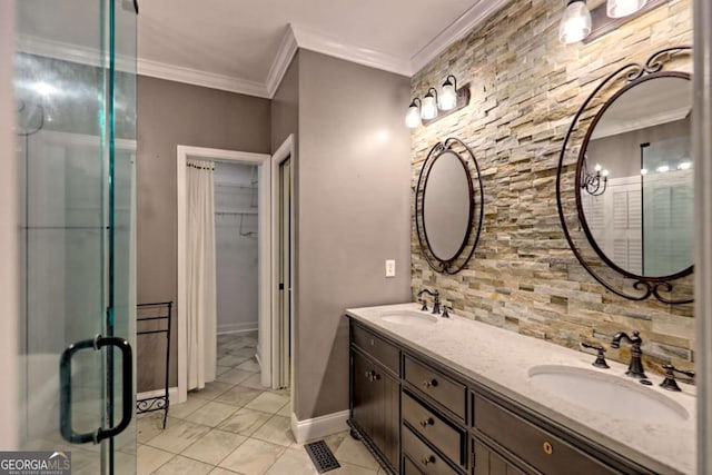 full bath with double vanity, crown molding, a spacious closet, and a sink