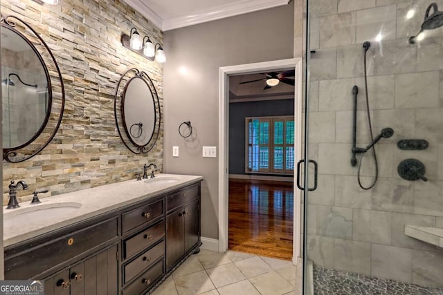 bathroom featuring crown molding, tile patterned flooring, a ceiling fan, and a sink