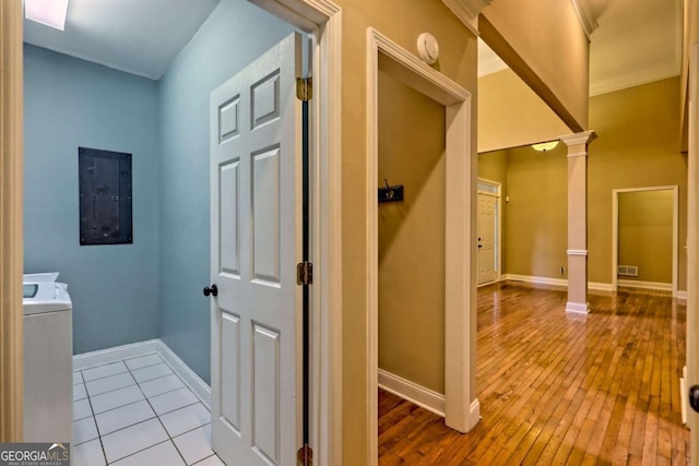 hallway with baseboards, ornate columns, wood-type flooring, and electric panel