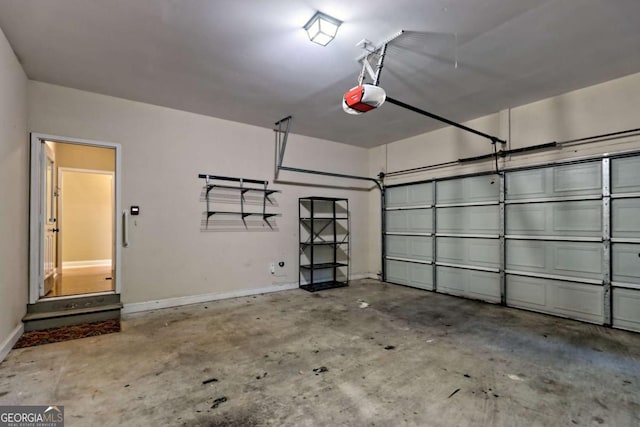 garage featuring baseboards and a garage door opener