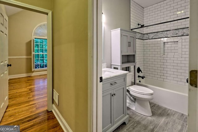 full bathroom featuring shower / bath combination, toilet, visible vents, vanity, and wood finished floors