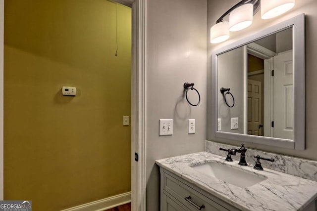 bathroom with vanity and baseboards