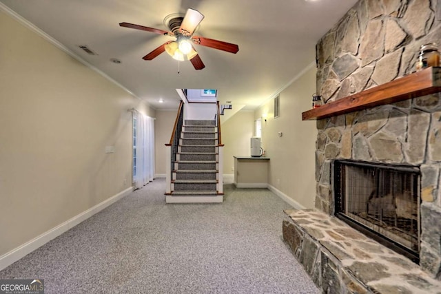 unfurnished living room with carpet, crown molding, visible vents, ceiling fan, and stairs