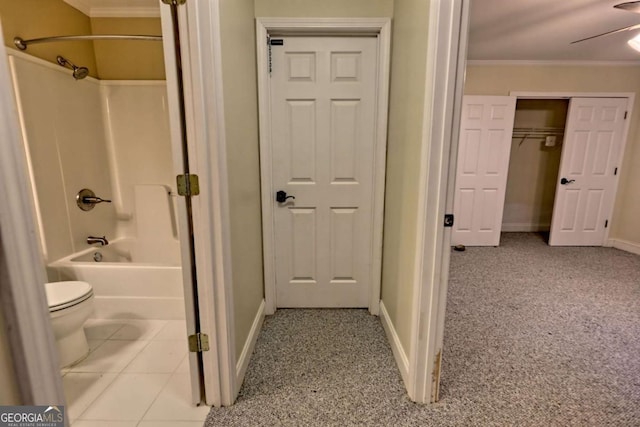 bathroom featuring toilet, baseboards, and ornamental molding