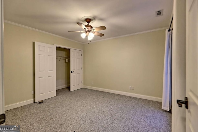 unfurnished bedroom with baseboards, ornamental molding, carpet flooring, ceiling fan, and visible vents