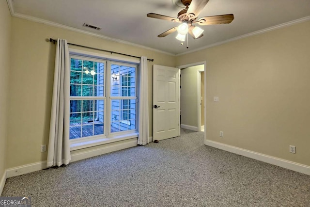 unfurnished room with crown molding, carpet floors, ceiling fan, and visible vents