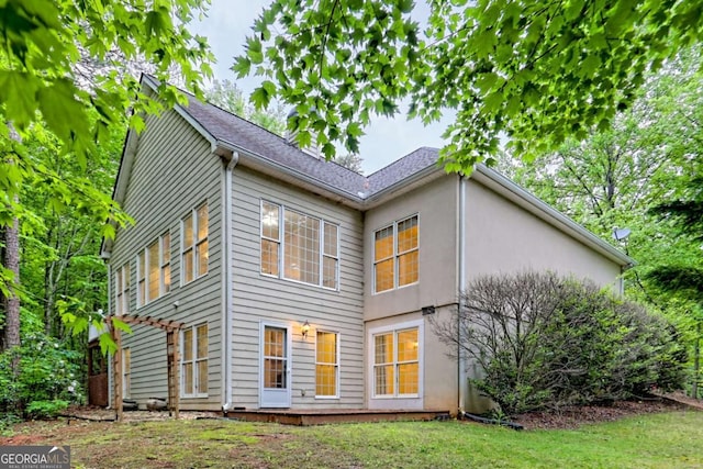 back of house featuring stucco siding