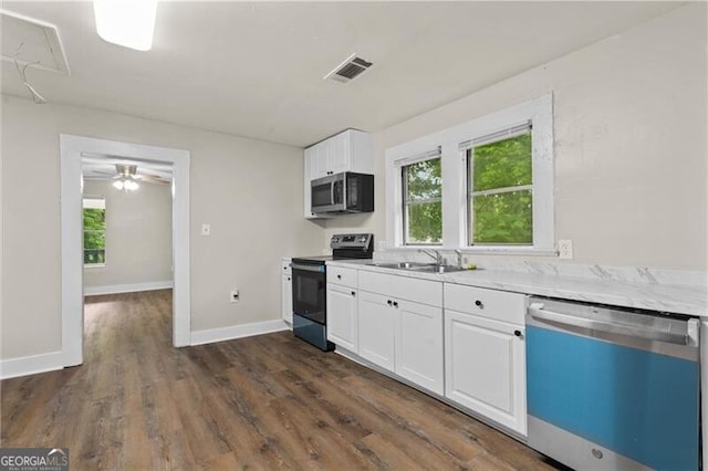 1939 Dunlap Ave, Atlanta, GA 30344 - kitchen featuring stainless steel microwave, a sink, dishwashing machine, visible vents, and range with electric cooktop