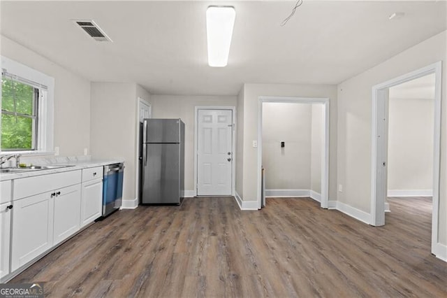 1939 Dunlap Ave, Atlanta, GA 30344 - kitchen featuring wood finished floors, a sink, white cabinetry, visible vents, and appliances with stainless steel finishes