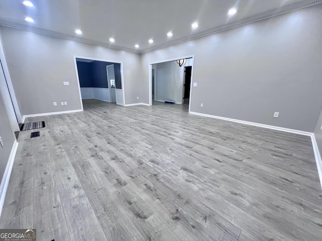 unfurnished room with baseboards, ornamental molding, recessed lighting, and wood finished floors