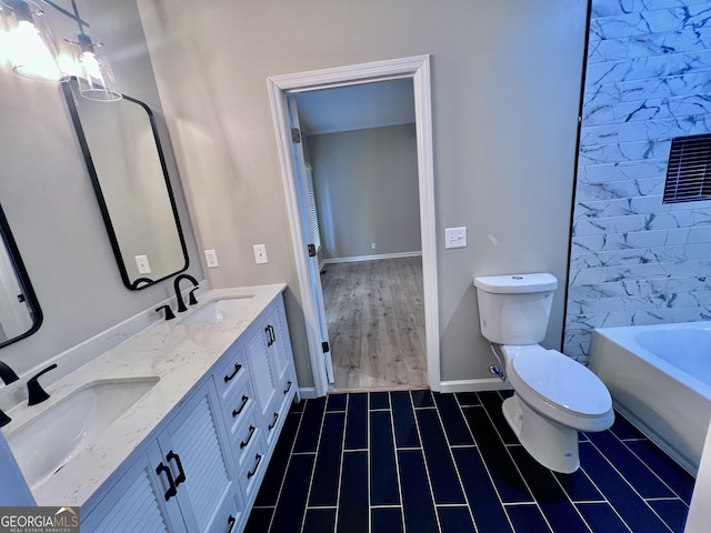 bathroom with toilet, a bathtub, double vanity, and a sink