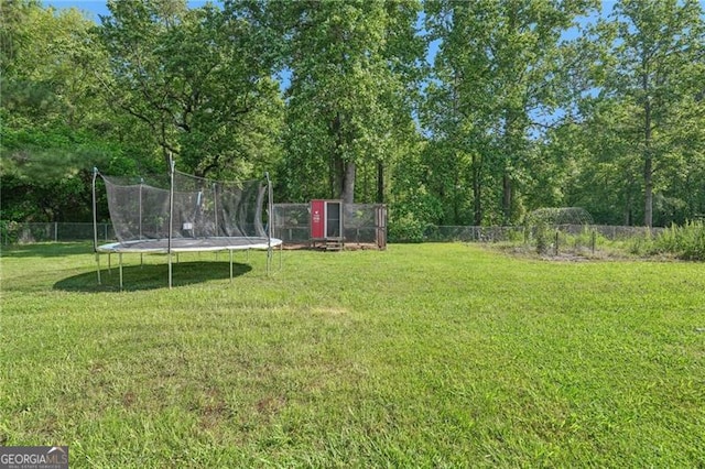 3880 Dial Mill Rd NE, Conyers, GA 30013 - view of yard with a trampoline and view of wooded area
