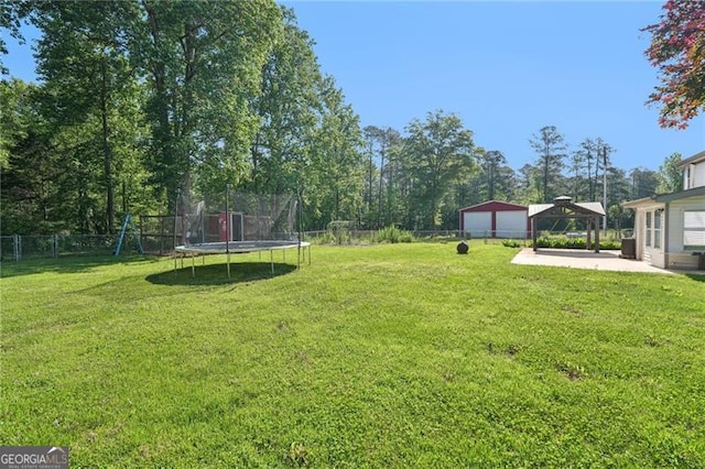 3880 Dial Mill Rd NE, Conyers, GA 30013 - view of yard with a trampoline, a patio area, a gazebo, a playground, and a detached garage