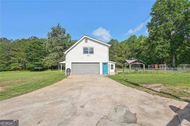 3880 Dial Mill Rd NE, Conyers, GA 30013 - view of property exterior featuring a garage and driveway