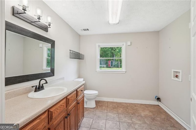 3880 Dial Mill Rd NE, Conyers, GA 30013 - bathroom featuring toilet, vanity, baseboards, and a textured ceiling