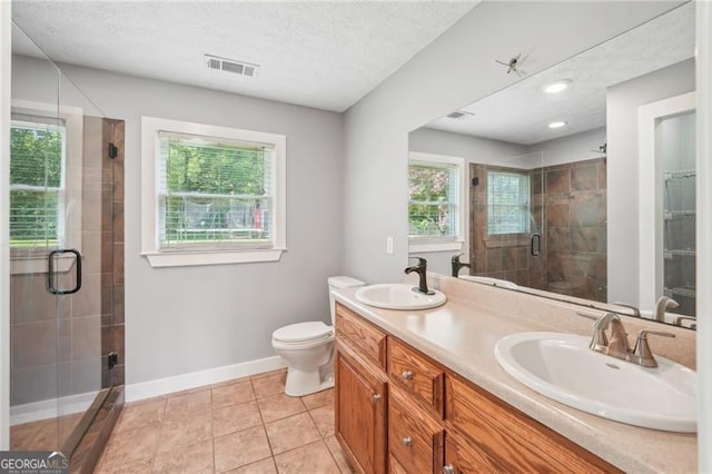 3880 Dial Mill Rd NE, Conyers, GA 30013 - full bath featuring a stall shower, baseboards, double vanity, a textured ceiling, and tile patterned floors