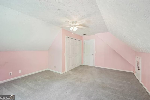3880 Dial Mill Rd NE, Conyers, GA 30013 - additional living space with a textured ceiling, a ceiling fan, carpet, vaulted ceiling, and baseboards
