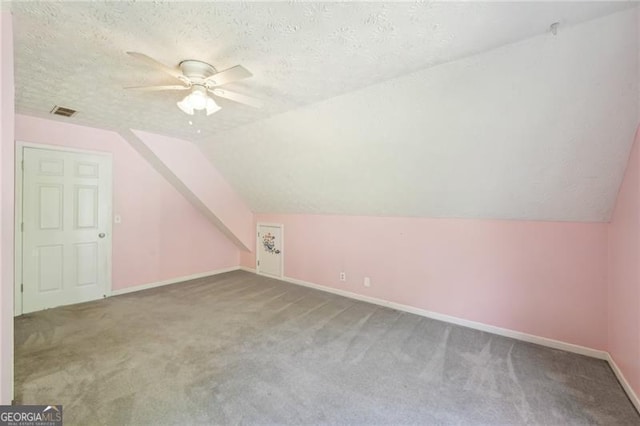 3880 Dial Mill Rd NE, Conyers, GA 30013 - additional living space with carpet floors, a ceiling fan, vaulted ceiling, a textured ceiling, and baseboards