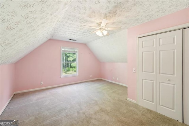 3880 Dial Mill Rd NE, Conyers, GA 30013 - additional living space featuring baseboards, carpet flooring, a textured ceiling, a ceiling fan, and lofted ceiling