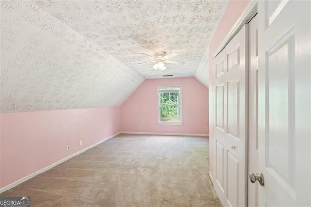 3880 Dial Mill Rd NE, Conyers, GA 30013 - additional living space featuring a textured ceiling, carpet, a ceiling fan, baseboards, and lofted ceiling