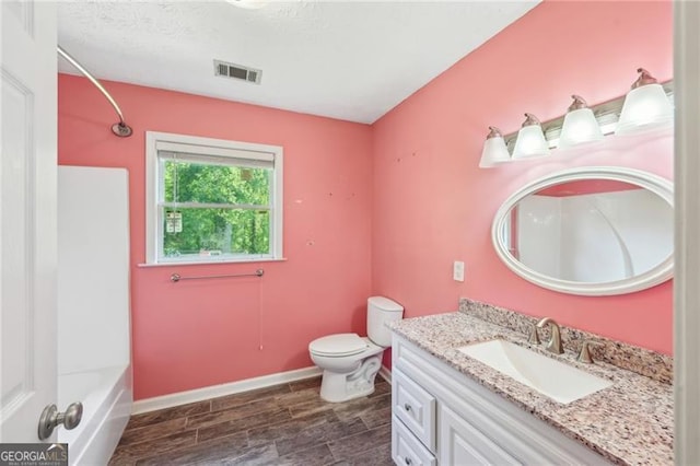 3880 Dial Mill Rd NE, Conyers, GA 30013 - full bath with vanity, toilet, wood tiled floors, and baseboards