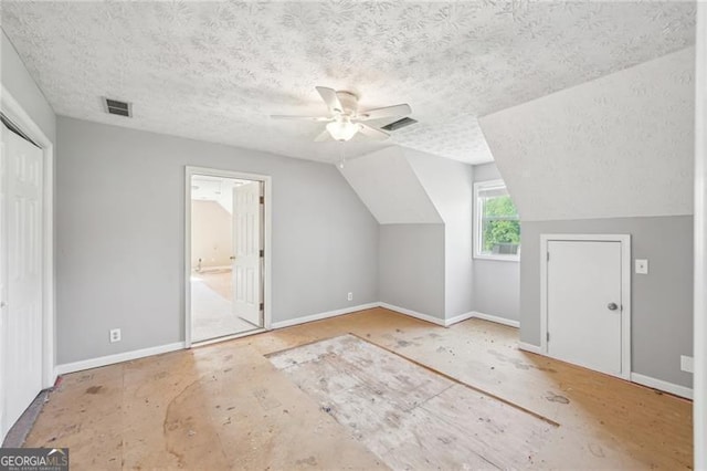 3880 Dial Mill Rd NE, Conyers, GA 30013 - additional living space featuring ceiling fan, a textured ceiling, baseboards, and vaulted ceiling