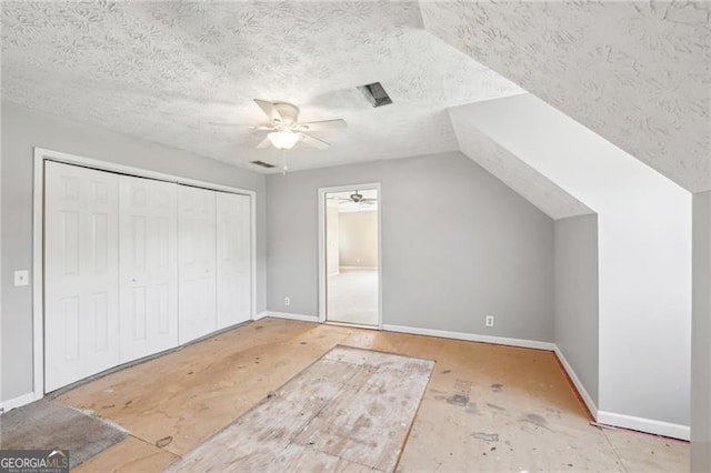 3880 Dial Mill Rd NE, Conyers, GA 30013 - bonus room featuring a ceiling fan, baseboards, a textured ceiling, and lofted ceiling