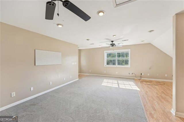 3880 Dial Mill Rd NE, Conyers, GA 30013 - unfurnished living room featuring a ceiling fan, baseboards, and lofted ceiling