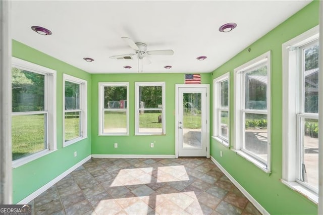 3880 Dial Mill Rd NE, Conyers, GA 30013 - unfurnished sunroom featuring baseboards and stone finish floors