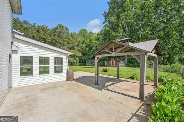 3880 Dial Mill Rd NE, Conyers, GA 30013 - view of patio featuring a trampoline, a gazebo, and concrete driveway