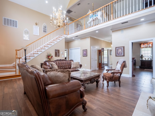 living room with visible vents, a towering ceiling, and stairway