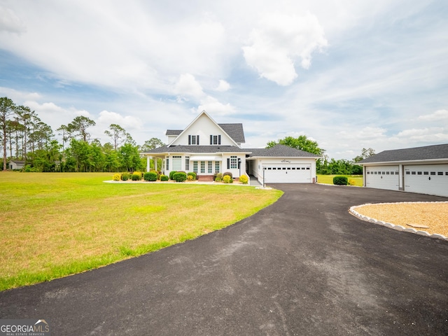 view of front of property with an attached garage, a front lawn, and driveway