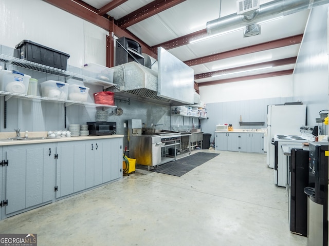 interior space with a sink, concrete flooring, open shelves, visible vents, and black microwave