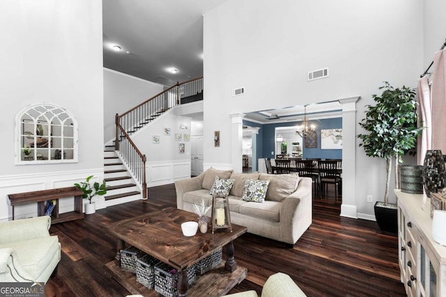 3016 Levinshire Way, Dacula, GA 30019 - living area with a towering ceiling, wood finished floors, visible vents, and decorative columns